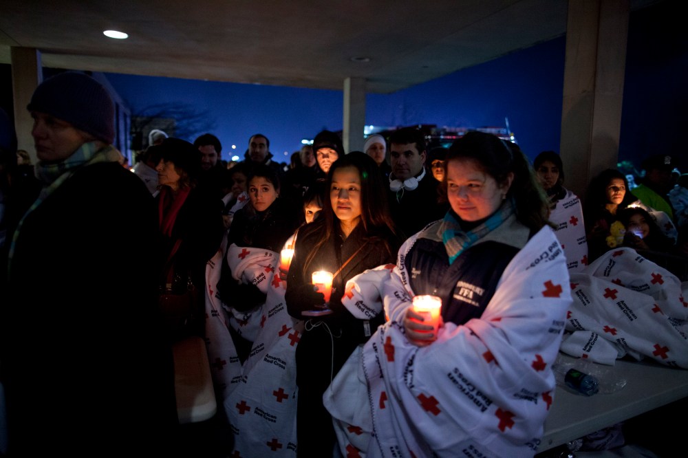Residents hold a candlelight vigil outside Newtown High School Sunday.(AP Photo/ Evan Vucci)