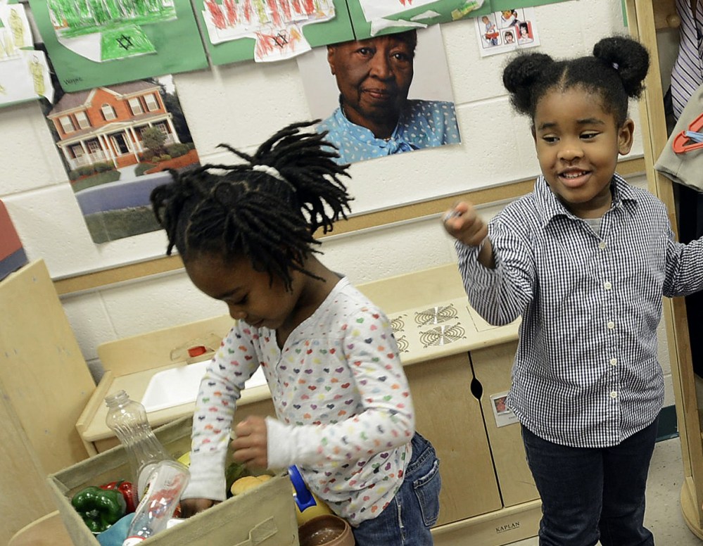Gov. Bev Perdue, right, listens to Amaya Bryant and Jalynn Brandon, left,  Monday, Dec. 10, 2012, at Primary Colors Early Learning Center in Durham, N.C. Perdue visited the Pre-K classes to highlight the importance of preschool. (AP Photo/The Herald...