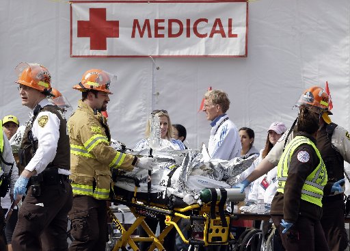 Medical personnel work outside the medical tent in the aftermath of two blasts which exploded near the finish line of the Boston Marathon in Boston, Monday, April 15, 2013. ( Photo by Elise Amendola/AP Photo)