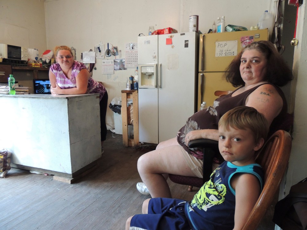 Renee Adams, left, posing with her mother Irene Salyers and son Joseph, 4, at their produce stand in Council, Va., July 12, 2013.