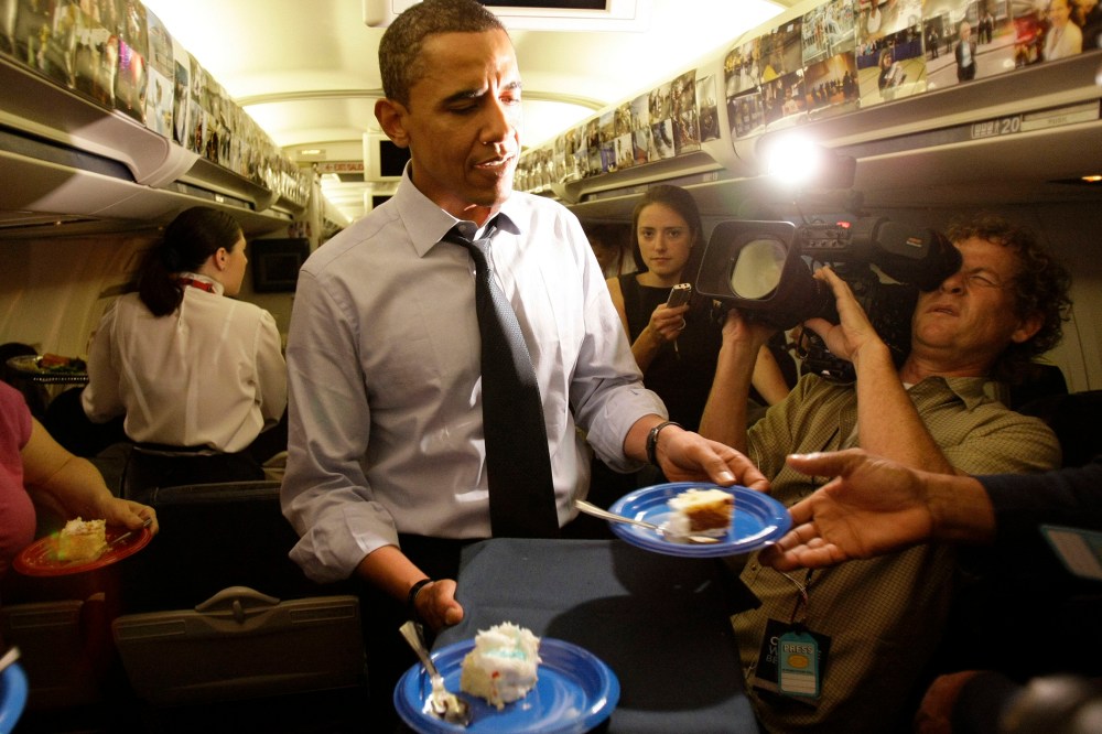 Then, Democratic presidential candidate Sen. Barack Obama, D-Ill., serves birthday cake to the press corps on his birthday while in flight, Aug. 4, 2008. (Photo by Alex Brandon/AP)