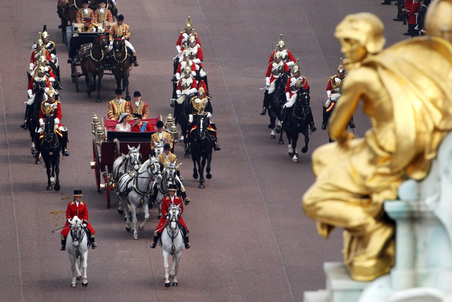 Their Royal Highnesses Prince William, Duke of Cambridge and Catherine, Duchess of Cambridge travel along the Mall following their marriage ceremony on April 29, 2011 in London, England. (Photo by Oli Scarff/Getty)