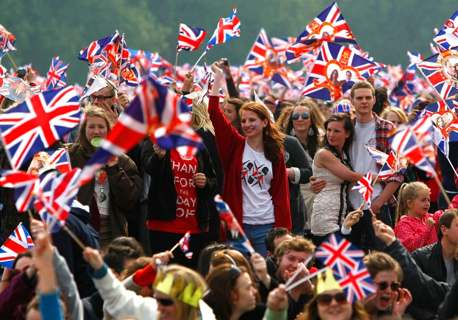 Spectators wave their flags in Hyde Park where big screens have been set up to watch the wedding ceremony on April 29, 2011 in London, England. (Photo by Tom Dulat/Getty)