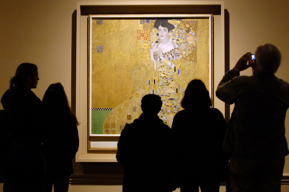Museum visitors study 1907 painting by Austrian artist Gustav Klimt in Los Angeles