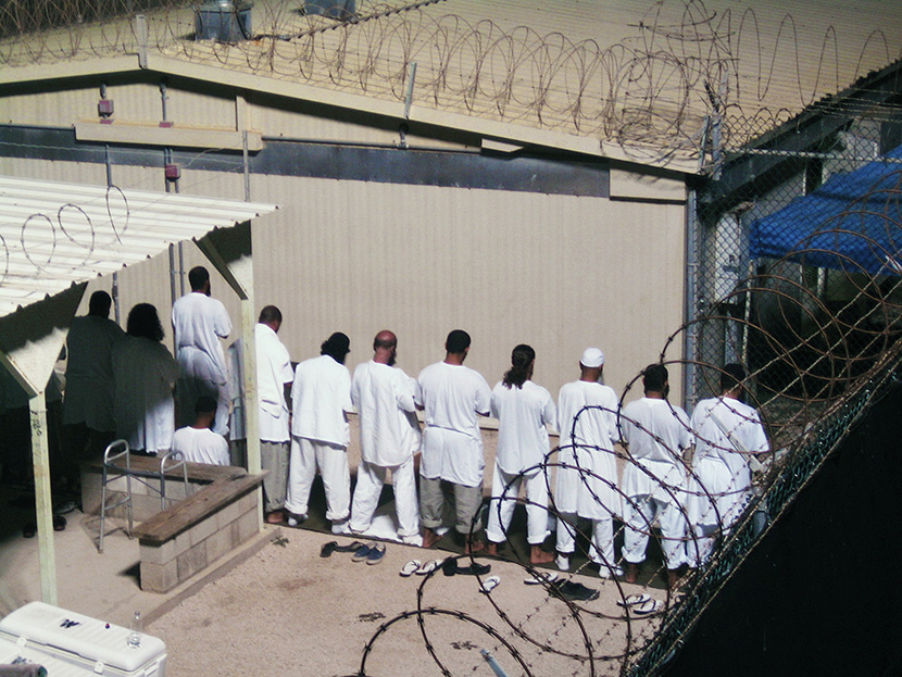 Detainees participate in an early morning prayer session at Camp IV at the detention facility in Guantanamo Bay U.S. Naval Base August 5, 2009. (Photo by Deborah Gembara/Reuters)