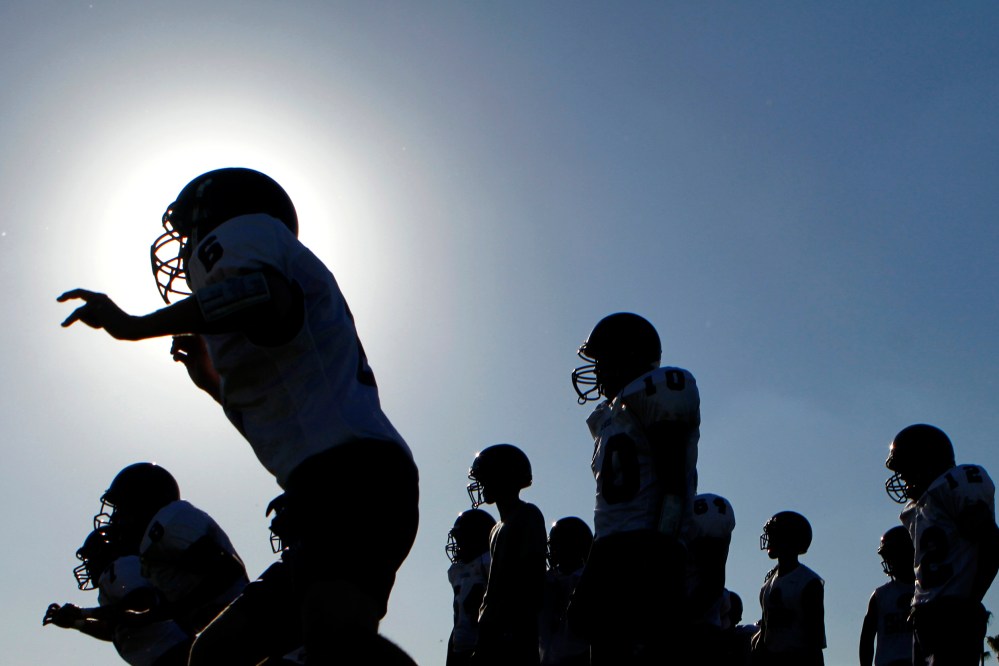 A high school football team practices for their upcoming season in Arizona.