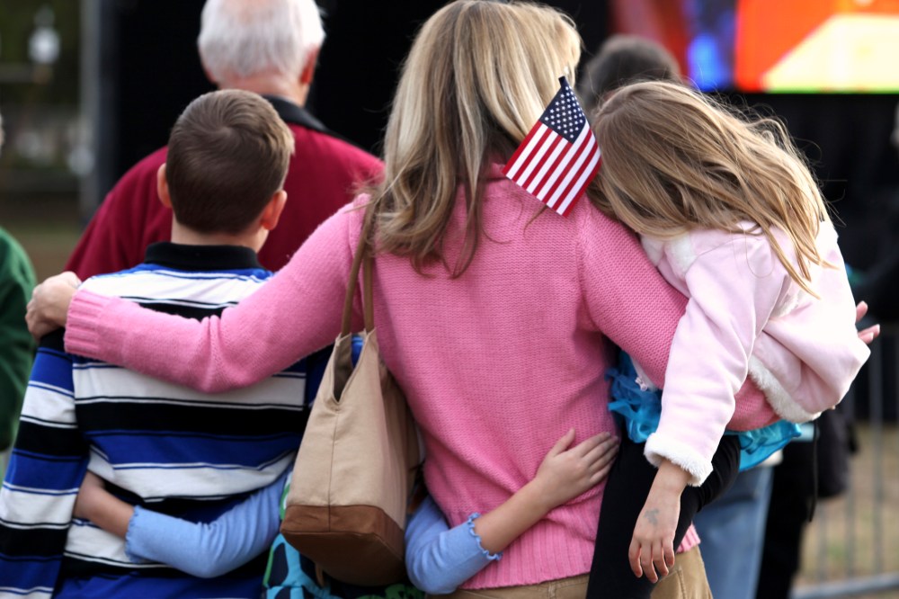 A mother huddles with her children while at an event in Myrtle Beach, South Carolina, Jan. 16, 2012.