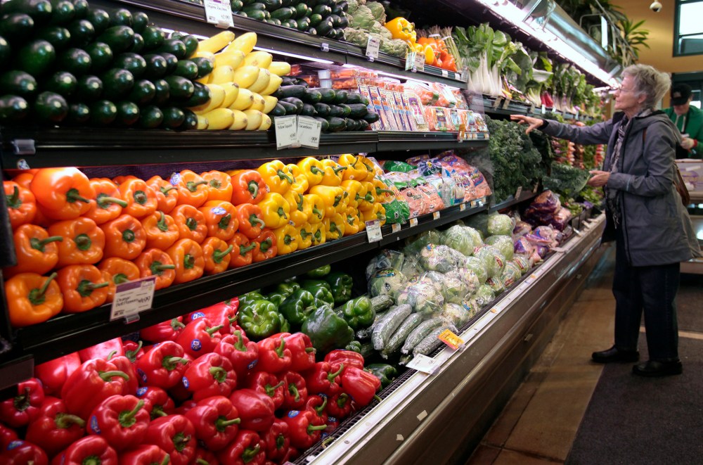 A customer shops for fresh produce at the Whole Foods grocery story in Ann Arbor, Mich., March 8, 2012. (Photo by Rebecca Cook/Reuters)