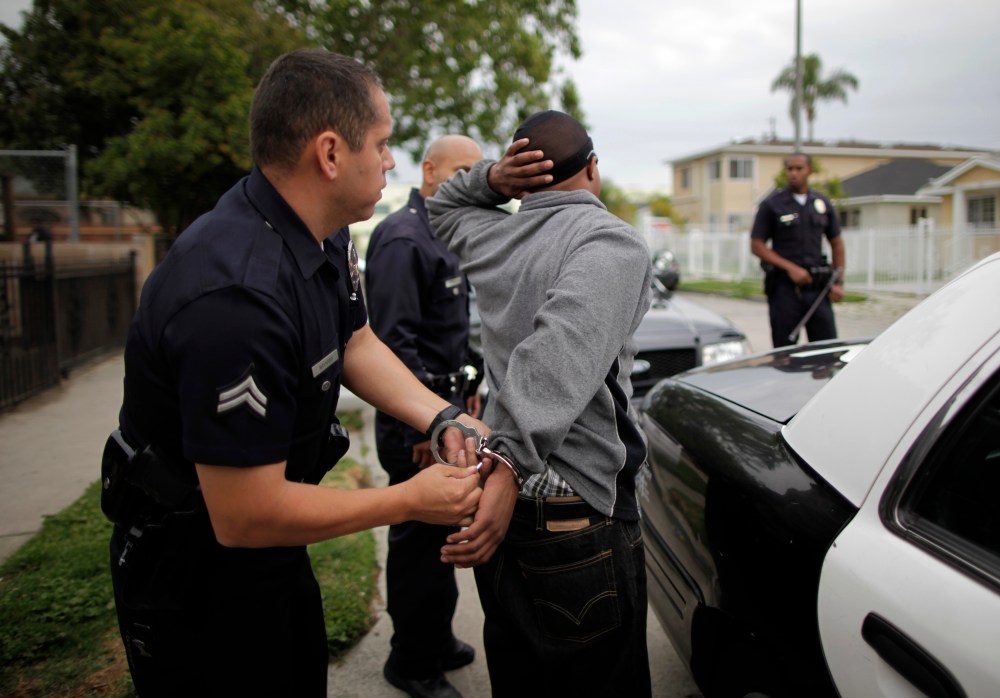 A man is handcuffed in south Los Angeles, California, April 25, 2012.