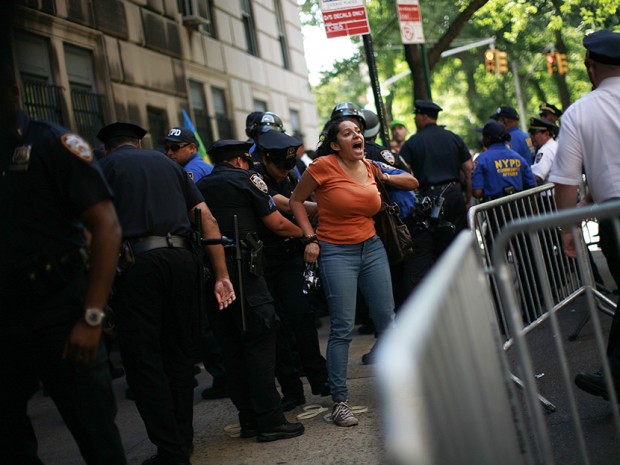 A woman is taken into custody by police following a protest in New York June 17, 2012. Thousands of New Yorkers marched in silence down Fifth Avenue on Sunday to demand an end to the New York Police Department's "stop-and-frisk" program, which the...