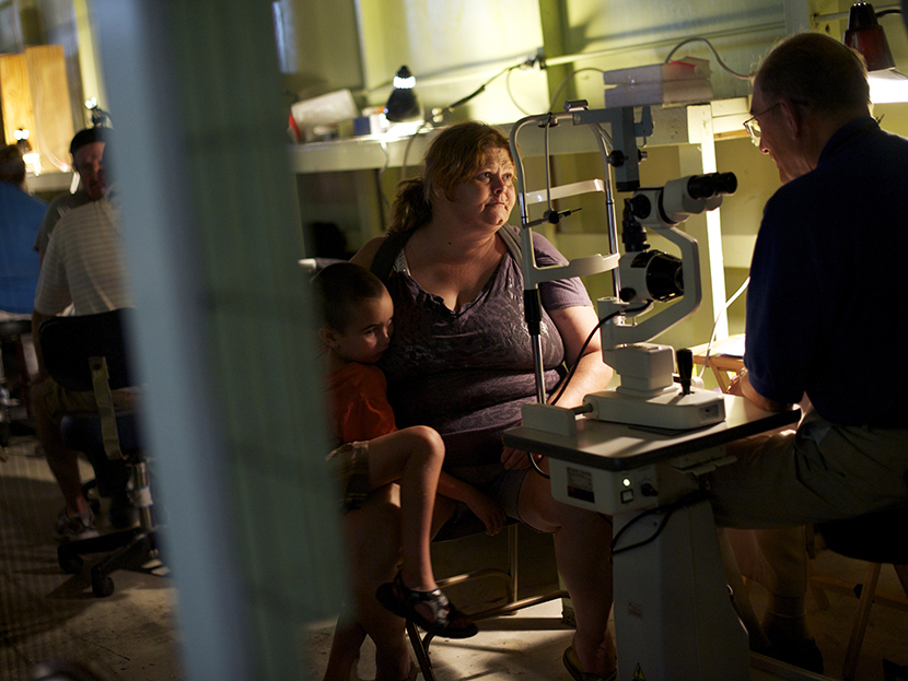 A patient has an eye exam at the Remote Area Medical (RAM) clinic in Wise, Virginia July 20, 2012. RAM clinics bring free medical, dental and vision care to uninsured and under-insured people across the country and abroad. (Photo by Mark Makela/AP)