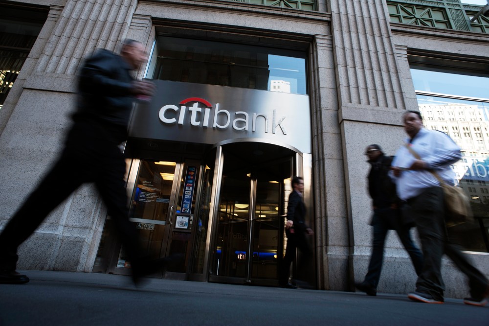 Passersby walk in front of a Citibank branch in New York