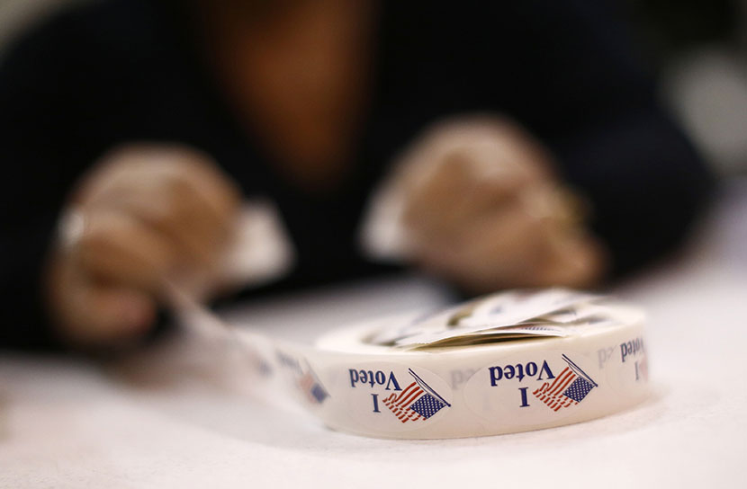 A poll worker prepares 'I Voted' stickers at Harrison United Methodist Church during the U.S. presidential election in Pineville, North Carolina November 6, 2012. (PHoto by Chris Keane/Reuters)