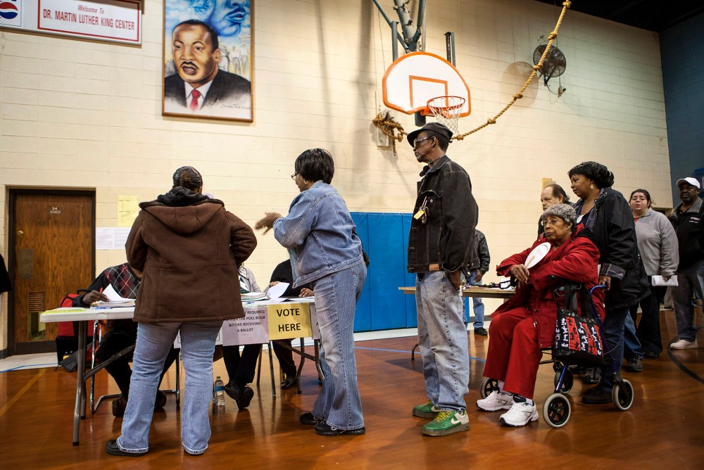 Voters sign in to vote at the Dr. Martin Luther King Community Center for the U.S. presidential election in Racine, Wisconsin on Nov. 6, 2012.