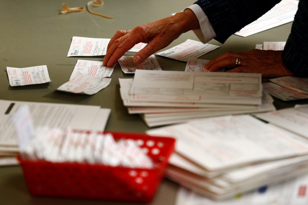A poll worker looks at voter authorization forms in Charlotte, North Carolina.