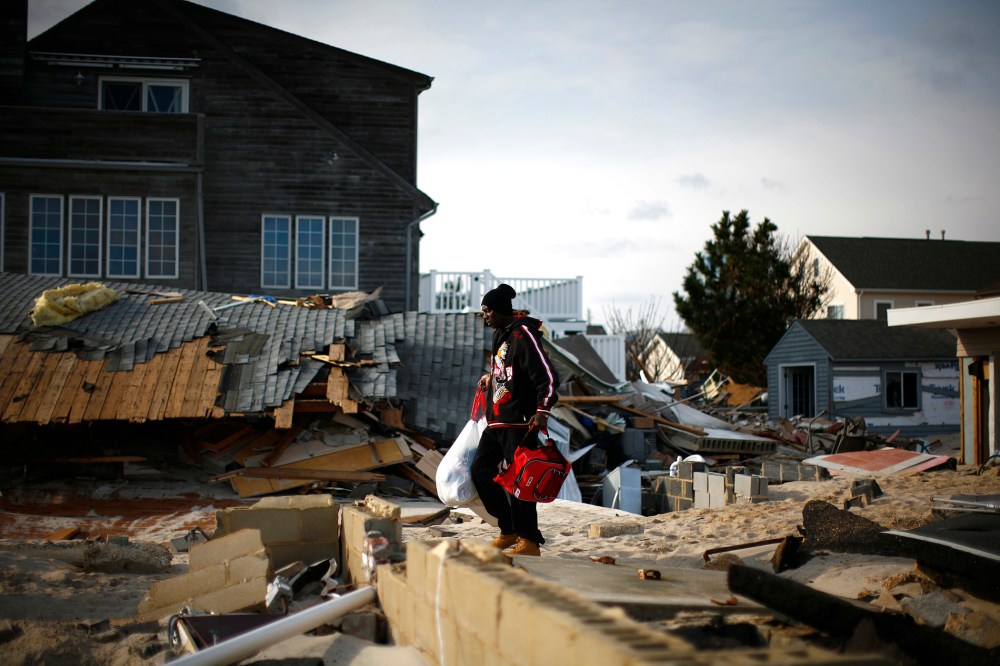 A man looks through homes damaged by Hurricane Sandy in Ortley Beach, New Jersey