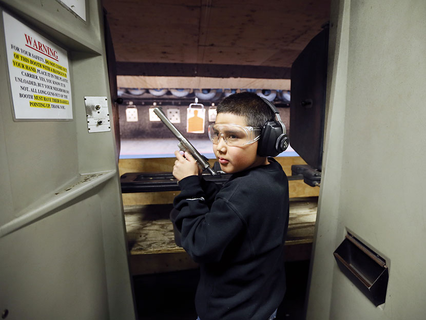 Andrew Josequera, 11, prepares to shoot at a target at the Los Angeles gun club in Los Angeles, January 23, 2013. (Photo by Lucy Nicholson/Reuters)