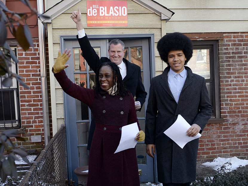New York City Public Advocate Bill de Blasio (C) waves to supporters with his wife Chirlane McCray (L) and son Dante as they leave their house to announce his Democratic candidacy for mayor in the Brooklyn borough of New York, January 27, 2013. (Photo...