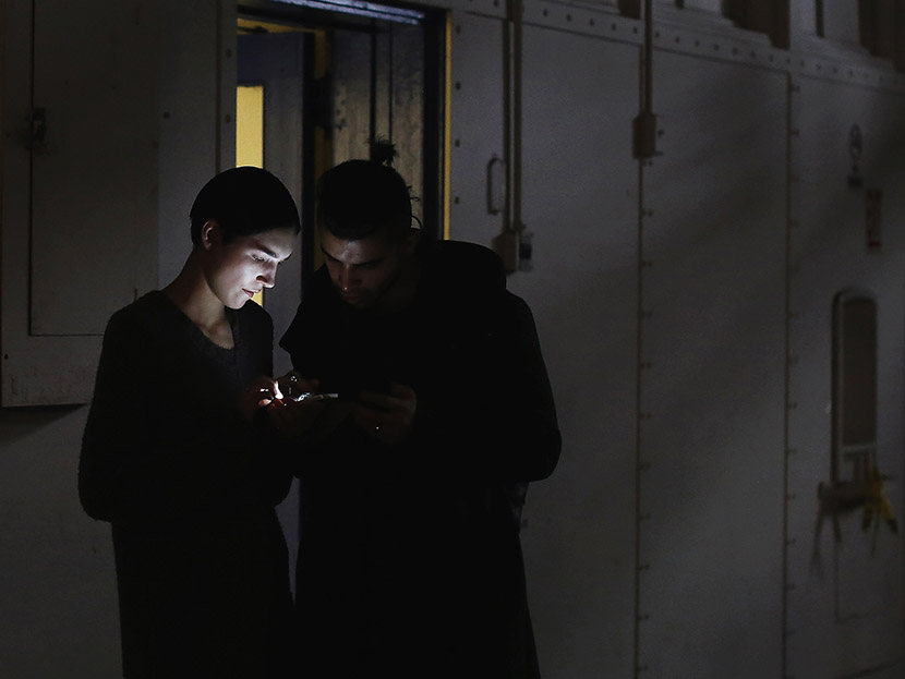 Models look at a mobile phone during New York Fashion Week on February 11, 2013.  (Photo by Shannon Stapleton/Reuters)