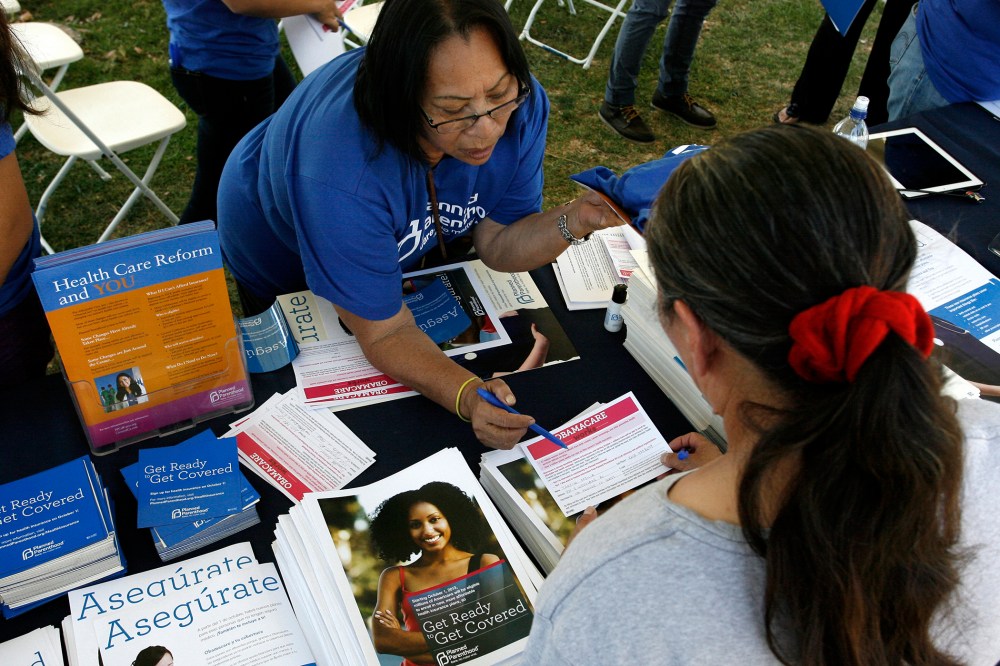 Planned Parenthood worker speaks with a woman during a Planned Parenthood Affordable Care Act outreach event