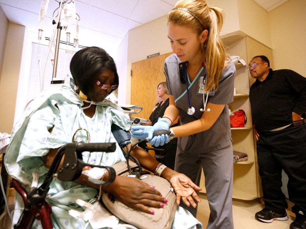 Registered nurse Paige Duracher checks Jacqueline Parker's vitals at the University of Mississippi Medical Center in Jackson, Mississippi October 4, 2013.