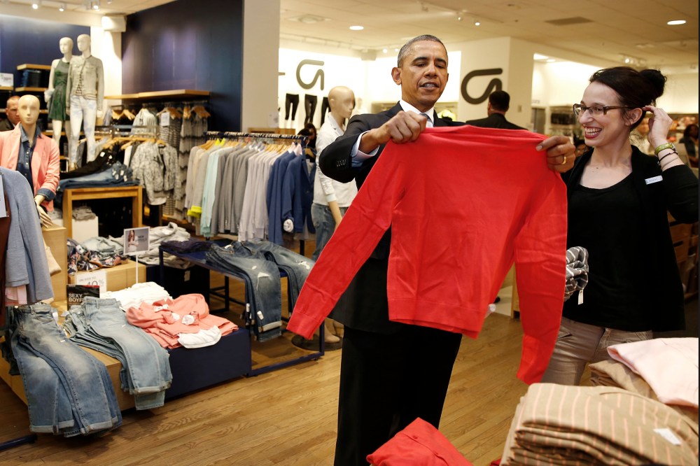 President Barack Obama looks for gifts for his family with salesperson Susan Panariello after stopping off at a GAP store in New York on March 11, 2014.