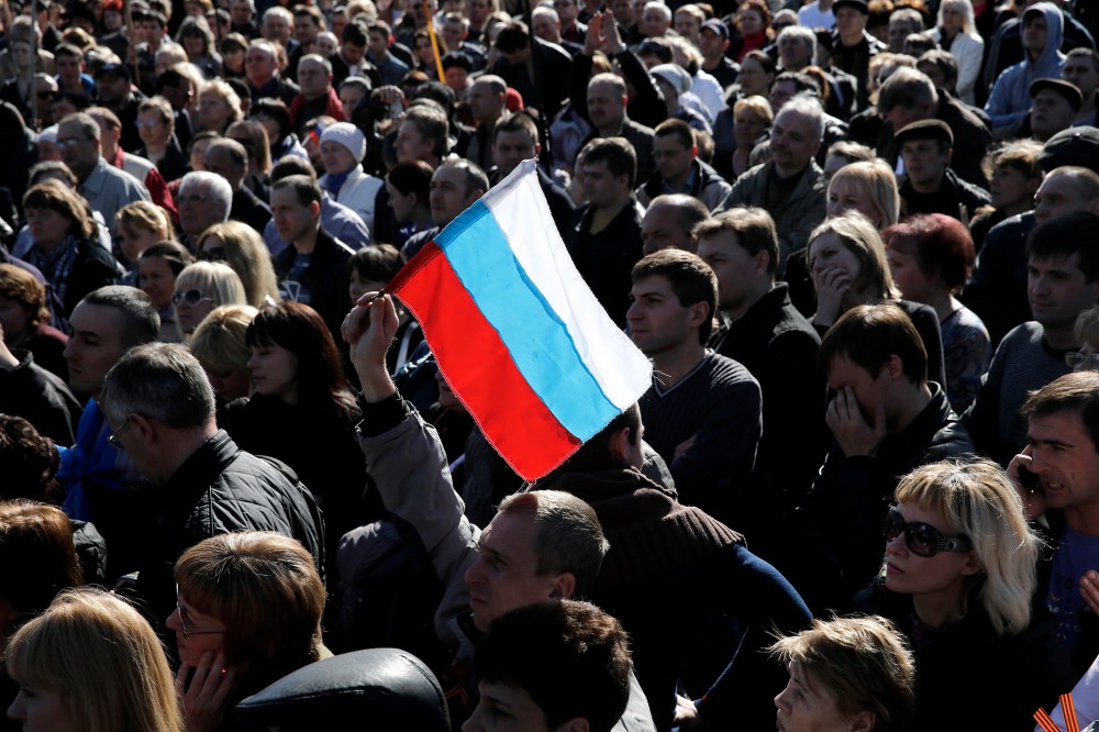 A pro-Russian activist holds a Russian flag during a rally in Donetsk's Lenin square March 23, 2014.