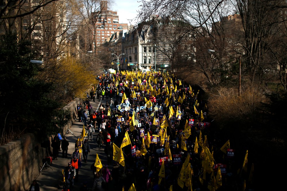 Members of the Service Employees International Union (SEIU) march out of Central Park onto 5th Avenue during a protest in New York City.