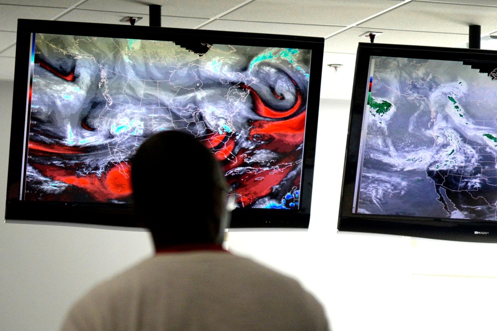 NOAA/SPC Severe weather forecasters keep track of the latest radar models at the National Weather Center in Norman, Okla. on April 25, 2014.
