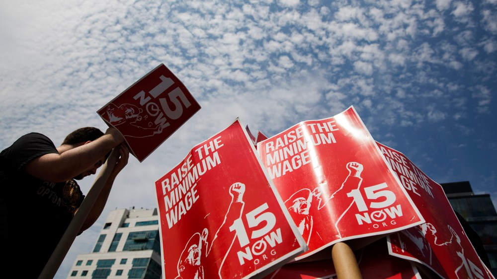 Demonstrators prepare signs supporting the raising of the federal minimum wage during May Day demonstrations in New York, N.Y., on May 1, 2014. (Photo by Lucas Jackson/Reuters)