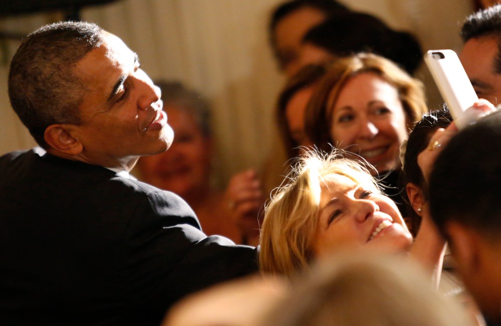 A woman makes a selfie as U.S. President Barack Obama greets guests at a Cinco de Mayo reception at the White House in Washington, May 5, 2014. (Photo by Yuri Gripas/Reuters)