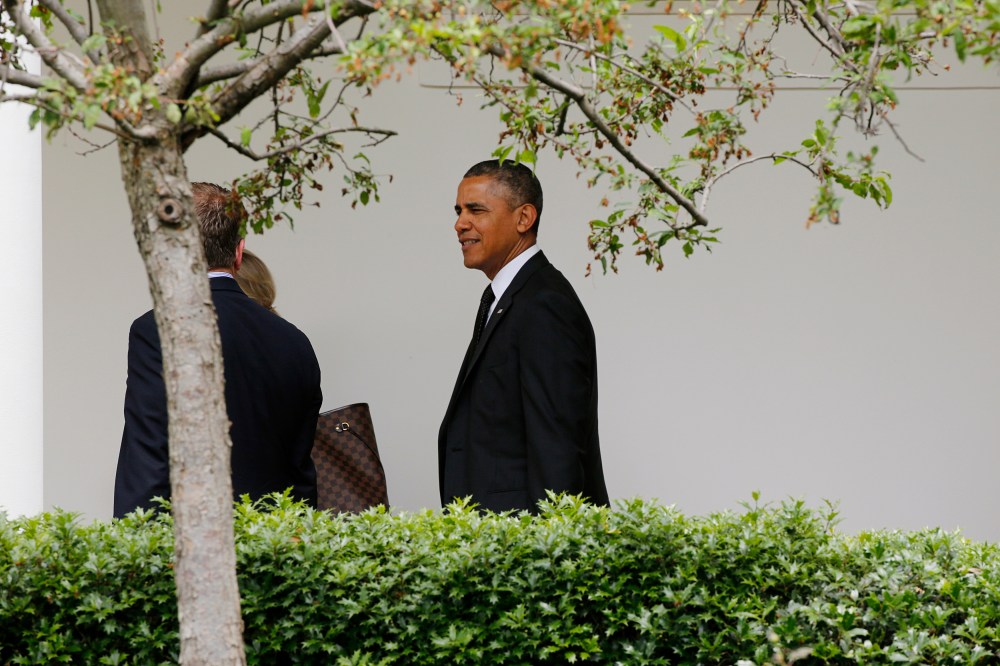 Obama talks with Carney as he walks up the White House colonnade heading into the West Wing returning to the White House in Washington