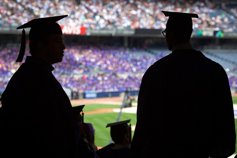 Graduates from New York University are silhouetted in the stands of Yankee Stadium during a commencement ceremony in the Bronx borough of New York.
