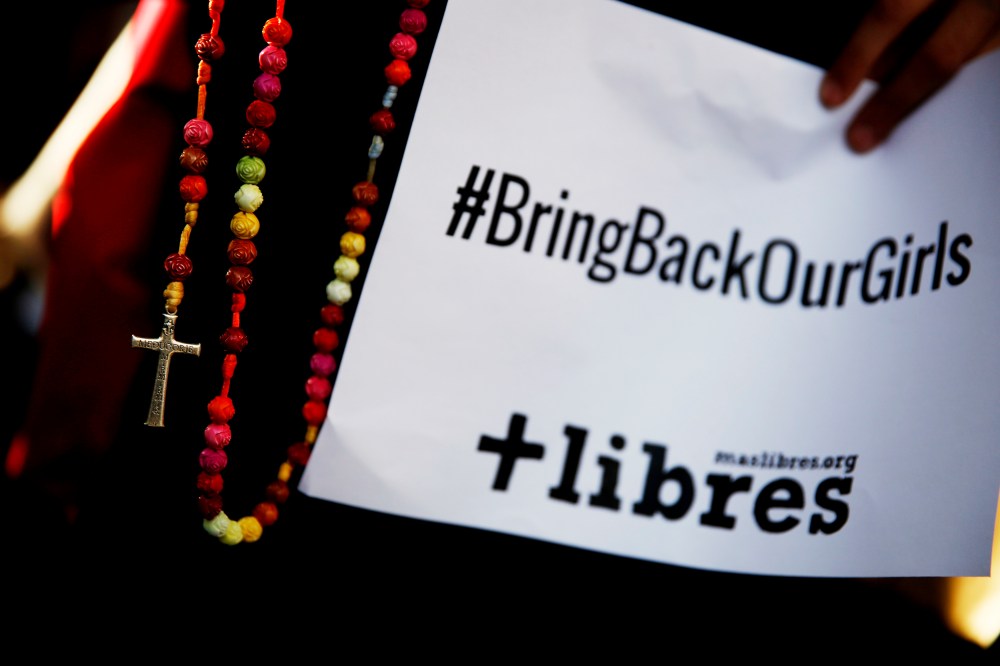 A poster with the Twitter campaign hashtag #BringBackOurGirls is seen during a prayer vigil showing support for Nigerian schoolgirls abducted by militant group Boko Haram, outside the Nigerian Embassy in Madrid May 22, 2014. (Photo by Susana Vera/Reuters)