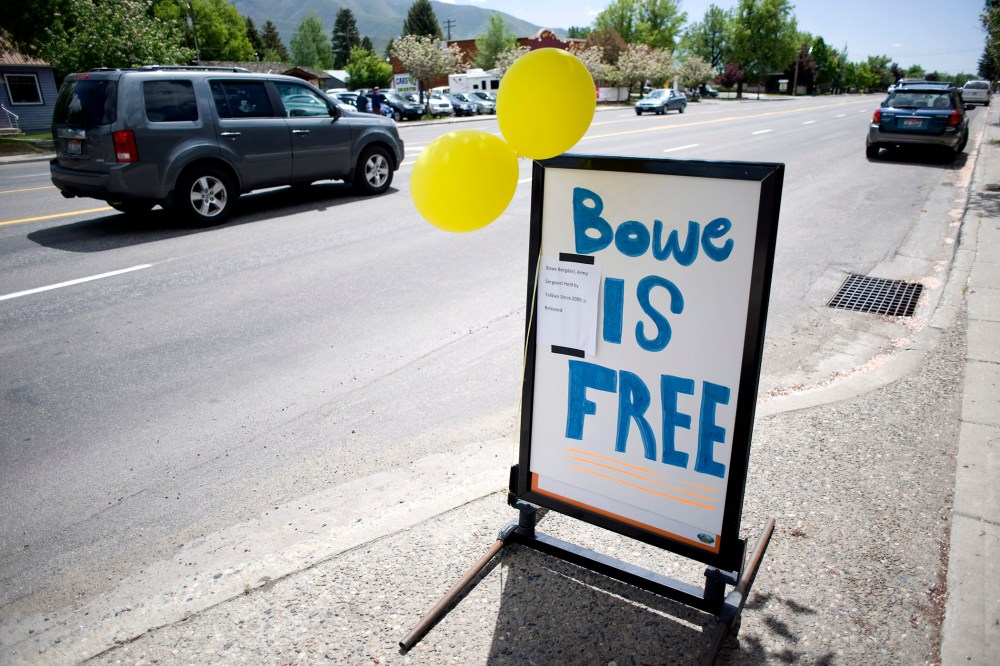 A car drives past yellow balloons and a sign of support for U.S. Army Sergeant Bergdahl in Hailey, Idaho