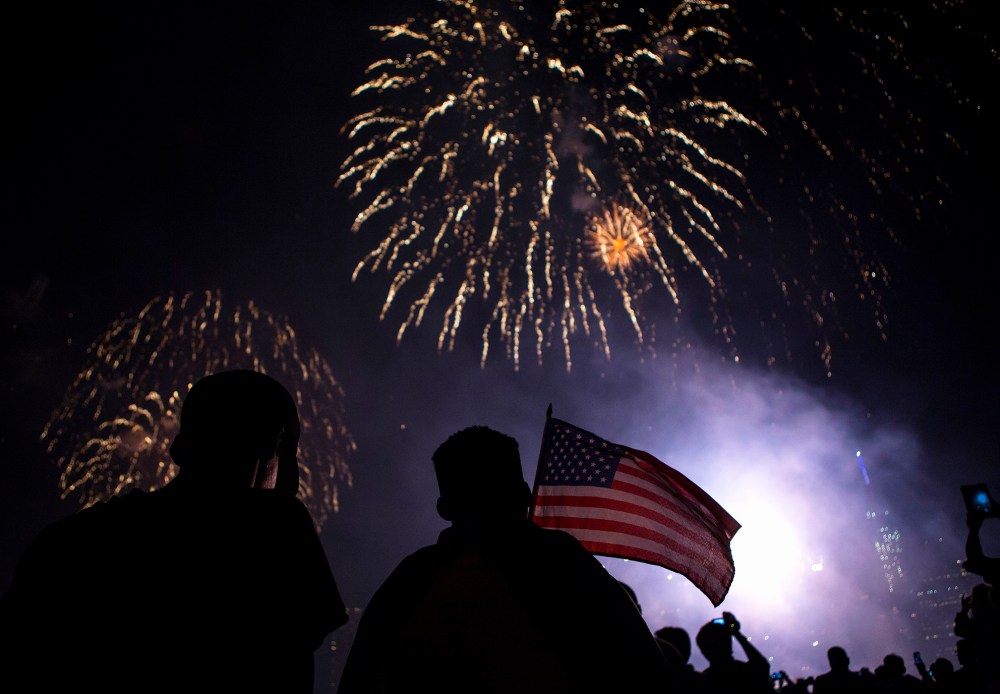 Spectators watch Macy's Fourth of July fireworks explode over the East River in New York July 4, 2014. (Photo by Eric Thayer/Reuters)