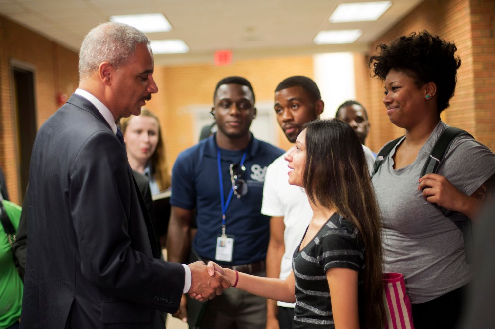 Attorney General Eric Holder shakes hands with Bri Ehsan, 25, following his meeting with students at St. Louis Community College Florissant Valley in Ferguson, Missouri August 20, 2014.