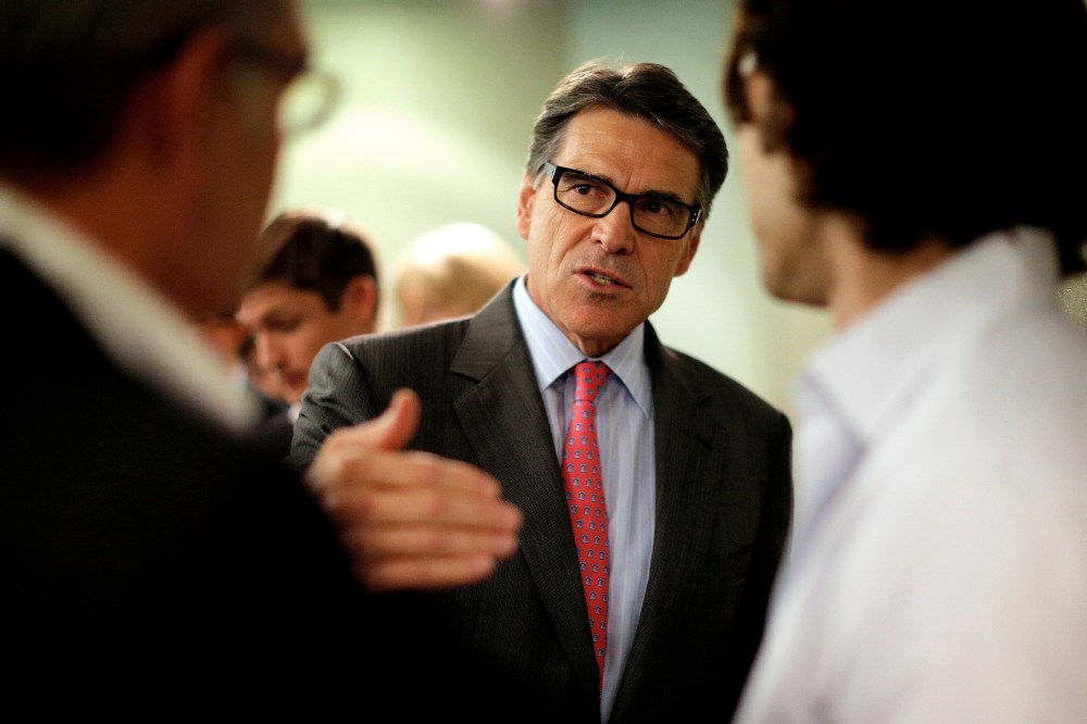 Texas Governor Perry, a possible Republican candidate for 2016 presidential race, talks several participants at business leaders luncheon in Portsmouth
