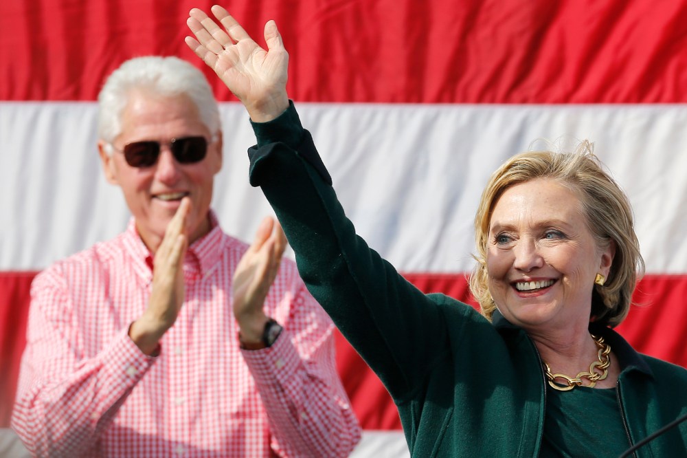 Former U.S. Secretary of State Hillary Clinton is applauded by her husband former U.S. President Bill Clinton at the 37th Harkin Steak Fry in Indianola, Iowa, Sept. 14, 2014.