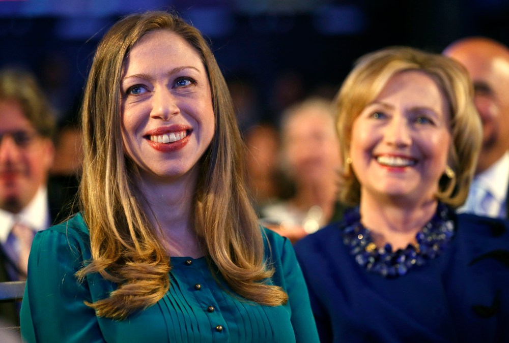 Former U.S. Secretary of State Hillary Clinton and her daughter Chelsea Clinton listen as U.S. President Barack Obama speaks at the Clinton Global Initiative in New York, Sep. 23, 2014. (Photo by Kevin Lamarque/Reuters)