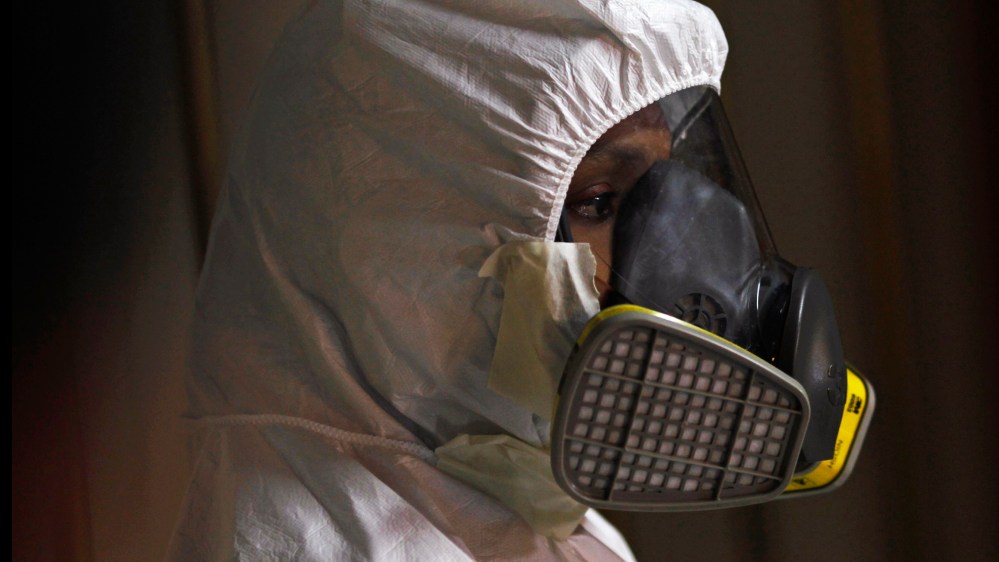 A paramedic from the fire department looks on after showing the media how to put on a protective suit, in Panama City October 2, 2014.