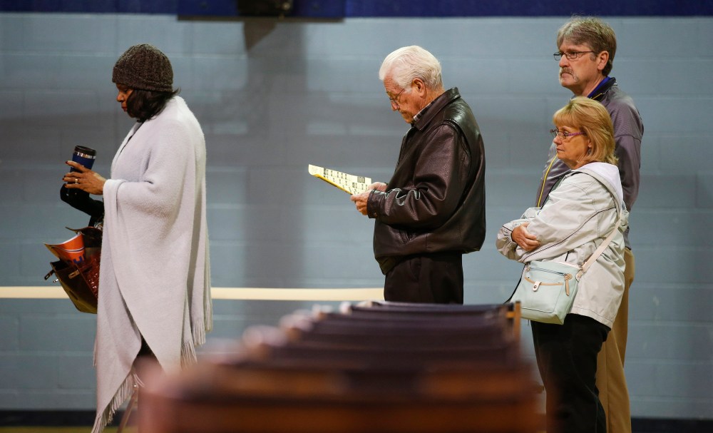 Voters stand in line before voting at the Grove Presbyterian Church in Charlotte