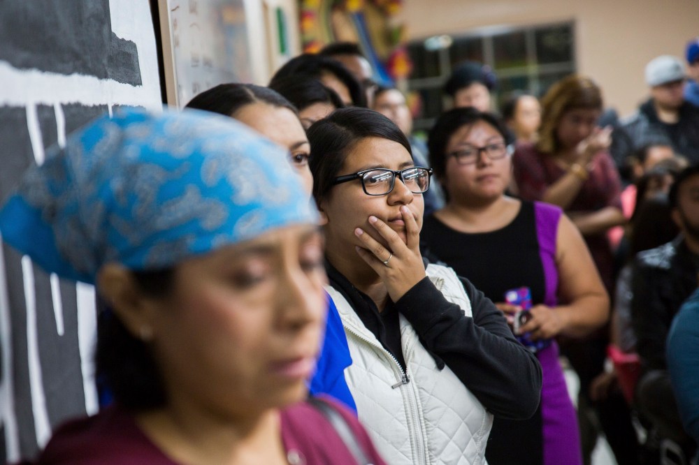 People watch U.S. President Barack Obama's national address in Phoenix