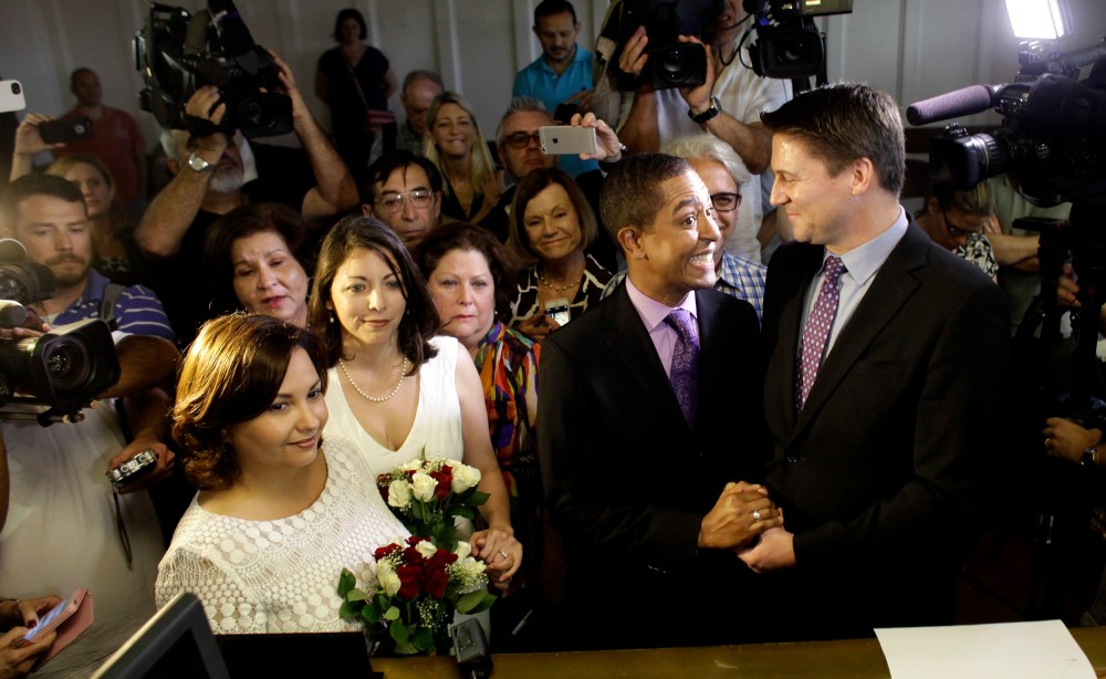 Same-sex couples Todd (2nd R), and Jeff Delmay with Catherina Pareto and Karla Arguello (L) get married at the Eleventh Judicial Circuit Court of Florida in Miami, Florida, Jan. 5, 2015. (Photo by Javier Galeano/Reuters)
