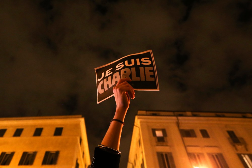 A woman holds a placard reading "I am Charlie," to pay tribute to victims following a shooting at the offices of weekly newspaper Charlie Hebdo in Paris, in front of the French embassy in Rome, Jan. 8, 2015. (Photo by Alessandro Bianchi/Reuters)