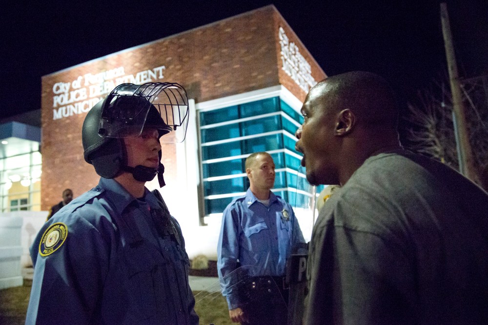 A protester confronts a police officer outside the City of Ferguson Police Department and Municipal Court in Ferguson, Missouri, March 11, 2015. (Photo by Kate Munsch/Reuters)