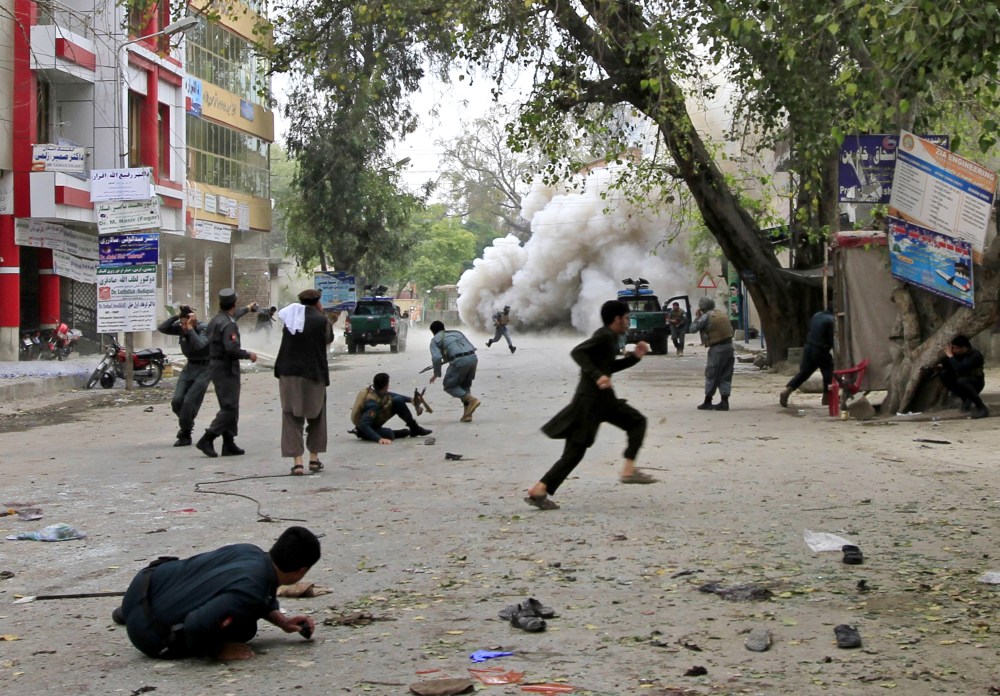 People run for cover after an explosion in Jalalabad April 18, 2015. A suicide bomb blast in Afghanistan's eastern city killed 33 people and injured more than 100 outside a bank where government workers collect salaries. (Photo by Parwiz/Reuters)