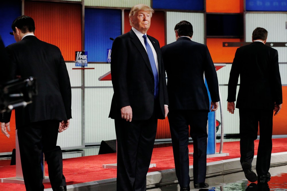 Republican presidential candidate Donald Trump remains standing at the front of the stage as his rivals head to their podiums at the start of a debate in Detroit, Mich., March 3, 2016. (Photo by Jim Young/Reuters)