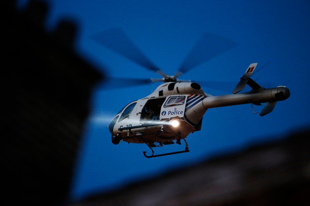 A police helicopter hovers over Brussels' rooftops following bomb attacks in Brussels, Belgium, March 22, 2016. (Photo by Christian Hartmann/Reuters)