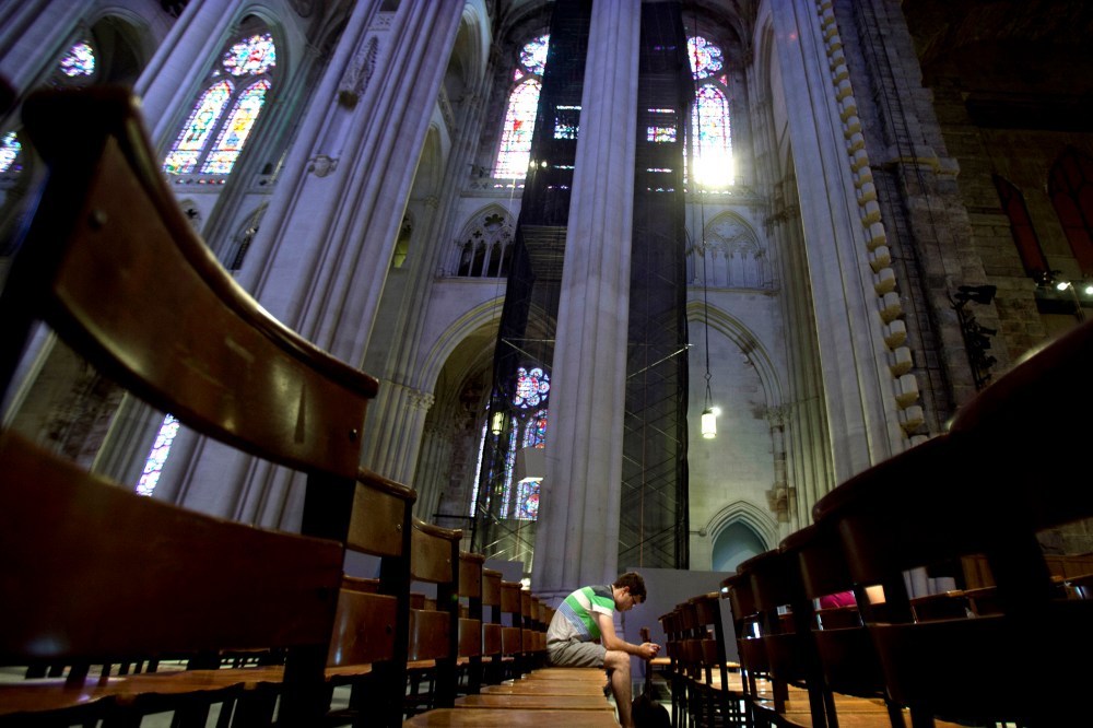 A man sits in the pews of Cathedral of St. John the Divine in New York, June 25, 2013.